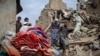 Afghan men walk on the rubble of a damaged house following a deadly magnitude-6 earthquake that struck eastern Afghanistan.