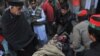 Rescuers move an injured man into a hospital following the attack on Bacha Khan university in Charsadda on January 20.