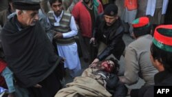 Rescuers move an injured man into a hospital following the attack on Bacha Khan university in Charsadda on January 20.