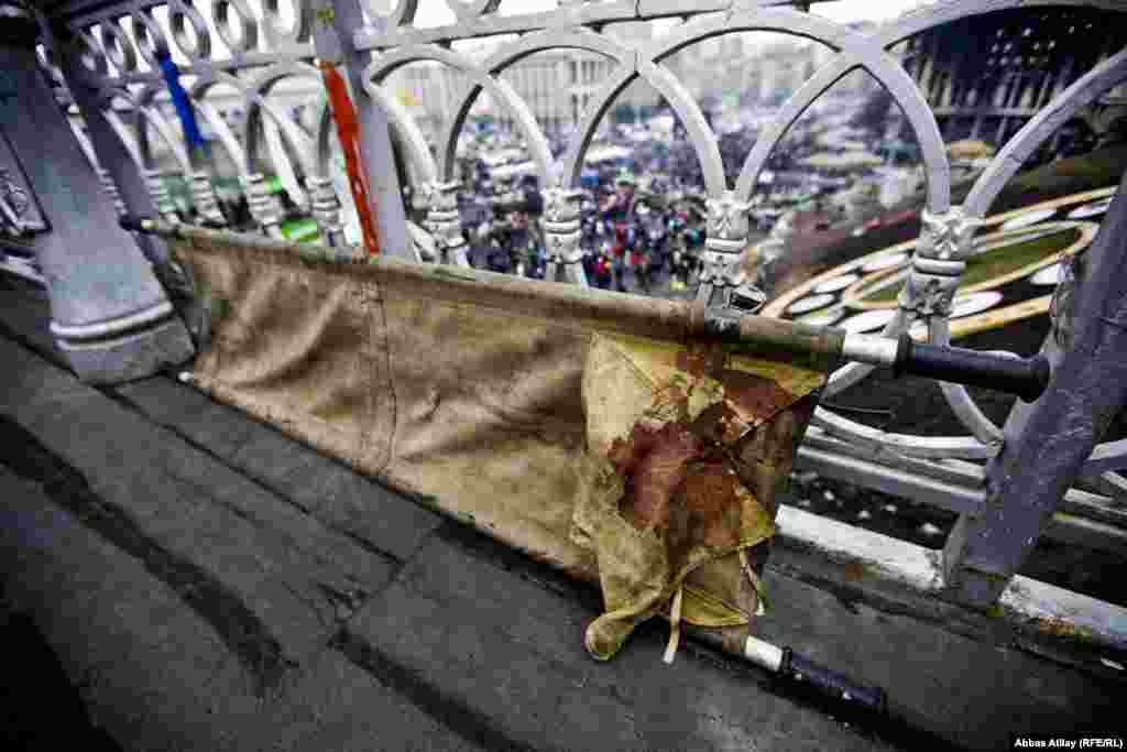 A bloody stretcher used to ferry the wounded sits against a railing overlooking Kyiv&#39;s Independence Square.