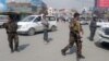 Afghan security forces keep watch near the site of a suicide bombing in Kabul on March 9.