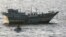 A photo distributed by the U.S. Navy showing a safety boat from the "USS Kidd" observing the January 5 boarding of Iran-flagged fishing dhow "Al Molai" in Arabian Sea after a reported distress call saying the fishing vessel had been captured by pirates.
