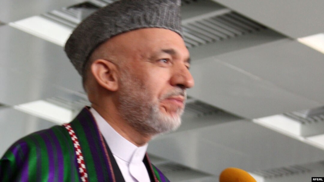 Hamid Karzai speaks to reporters after voting in Kabul on August 20.