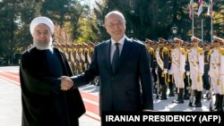 A handout picture provided by the Iranian presidency on November 17, 2018, shows Iran's President Hassan Rouhani next to Iraq's President Barham Salih (R) during a welcome ceremony in Tehran.