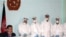 Afghan Health Minister Said Mohammad Amin Fatami speaks at a press conference on November 2 about swine flu. He is surrounded by doctors dressed in full protective suits from a Kabul lab designed to diagnose the H1N1 virus.