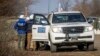 OSCE observers man a checkpoint in the Luhansk region. After the beginning of Russia's full-scale invasion of Ukraine in February, the OSCE evacuated about 500 observers of its mission that monitored the cease-fire in the region. (file photo)