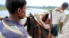 Rohingya refugees carry an elderly woman from Rakhine state in Myanmar along a path near Teknaf in Bangladesh on September 3.