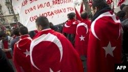 People wearing the Turkish flag take part in a rally next to the French National Assembly in Paris in mid-December.