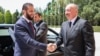 This handout picture released by the Syrian Presidency shows Azerbaijan's President Ilham Aliyev (right) receiving Syria's interim President Ahmed al-Sharaa in Baku on July 12.