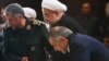 Iranian president Hassan Rouhani (C) alongside IRGC's top commander Mohammad Ali Jafari (L) and his brother Hossein Fereydoun in a ceremony in Tehran On September 16, 2013.