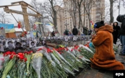 A woman prays during a memorial ceremony marking the first anniversary of the killings of demonstrators in the final act of a dramatic uprising around Independence Square, known as Maidan, in Kyiv, on February 20.