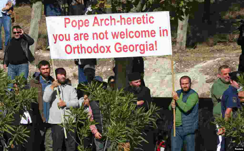 People hold a banner against the visit of Pope Francis to Georgia and Azerbaijan in Tblisi, Georgia, on September 30. Georgia is overwhelmingly Orthodox Christian, but has a 2.5 percent Catholic minority, according to Vatican estimates. (Reuters/Alessandro Bianchi)