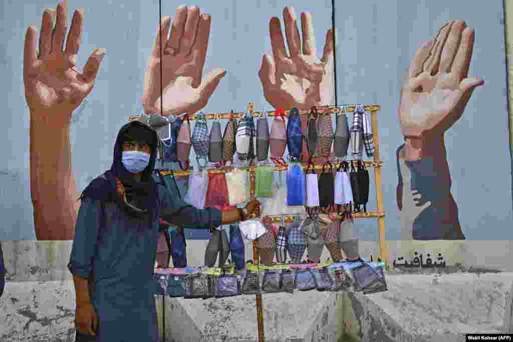 A street vendor selling face masks waits for customers in Kabul. Early optimism that South Asia might have dodged the worst ravages of the coronavirus pandemic has disappeared as soaring infection rates turn the densely populated region into a global hot spot. (AFP/Wakil Kohsar)