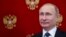 Russian President Vladimir Putin attends a joint press conference with his Slovenian counterpart following their talks at the Kremlin in Moscow on February 10.