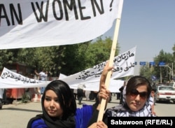 Afghan women march in Kabul on July 11 to protest the public execution of a young woman for alleged adultery.