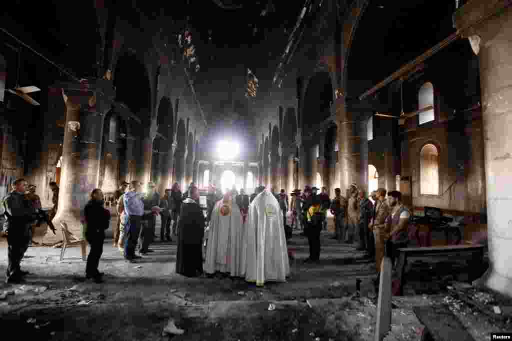 Iraqi priests hold the first Mass at the Grand Immaculate Church since it was recaptured from Islamic State militants in Qaraqosh, near Mosul, Iraq, on November 2. (Reuters/Alaa Al-Marjani)