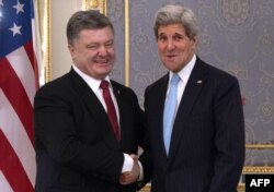 U.S. Secretary of State John Kerry (right) shakes hands with Ukrainian President Petro Poreshenko ahead of their talks.