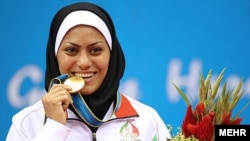 Khadijeh Azadpour celebrates her gold medal in in Guangzhou on November 17.