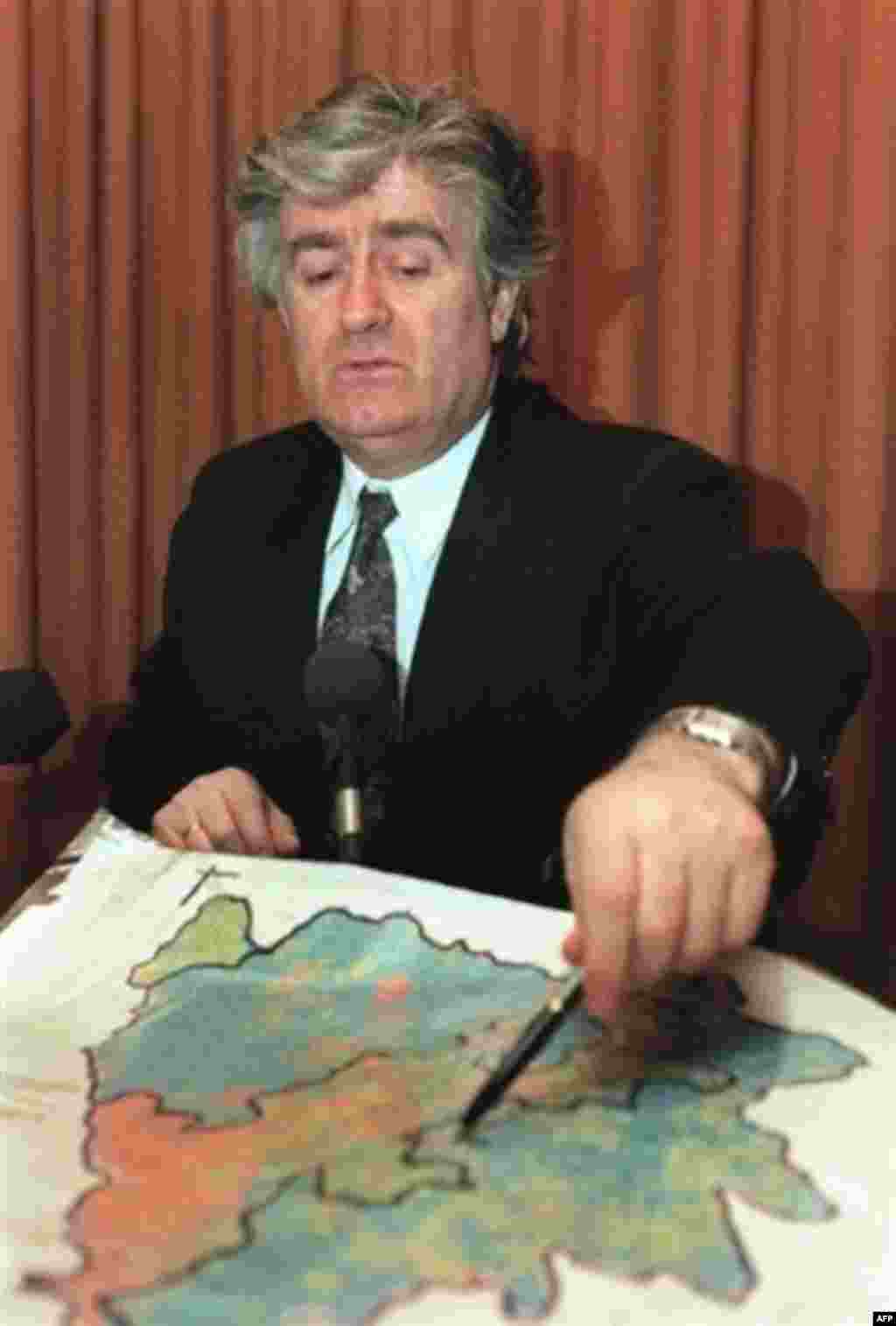 Karadzic displays a map of Bosnia's ethnic makeup at his headquarters in Pale in 1993 - During Bosnia's 1992-95 war, Karadzic sought to radicalize ethnic groups while leading Bosnian Serb forces against Bosnian Muslims and Croats who declared independence from Yugoslavia. He received support from the Yugoslav National Army under the control of Slobodan Milosevic. In 1991, Karadzic told Bosnia-Herzegovina's parliament that "Muslims will disappear from the Earth." 