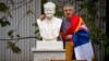 A man poses for a photograph next to the grave of late Yugoslav President Slobodan Milosevic in the town of Pozarevac, March 11, 2016