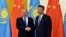 Kazakh President Nursultan Nazarbayev (L) and Chinese President Xi Jinping shake hands before their meeting at the Great Hall of the People, on the sidelines of the Belt and Road forum in Beijing on May 14.