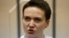 Detained Ukrainian pilot Nadia Savchenko stands inside the defendant's cage during her hearing in a Moscow court on November 11, 2014.