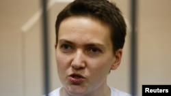 Ukrainian military pilot Nadia Savchenko speaks inside a defendants' cage as she attends a court hearing in Moscow in November 11.