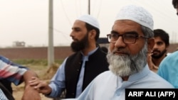 Amin Ansari, whose 7-year-old daughter was found raped and murdered, leaves the Kot Lakhpat Jail in Lahore on October 17 following the execution of Imran Ali, who was convicted of the crime.