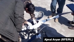 Afghan forces dismantle a Taliban drone shot down in Kunduz Province in March 2020.