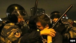 Russian police detain protesters in Moscow in October 2013. After years of squashing rights activists, is the Kremlin changing tactics?