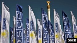 Kazakhstan -- Flags with the logos of the OSCE and the 2010 Kazakh Chairmanship in Astana, 28Jun2010