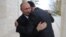 Russian President Vladimir Putin (left) and his Syrian counterpart, Bashar al-Assad, embrace in Sochi on November 20.