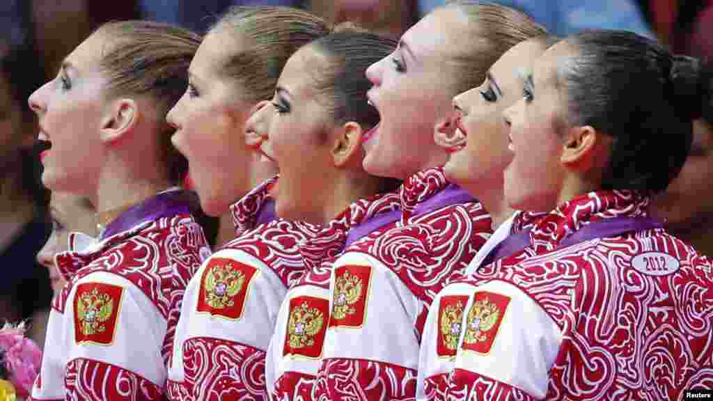 Team Russia sing their national anthem as they celebrate with their gold medals in the victory ceremony after the group all-around rhythmic gymnastics final at the London Games. (Reuters/Mike Blake)