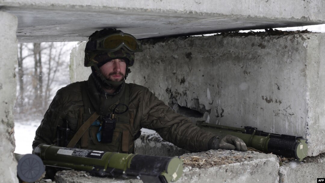 A Ukrainian serviceman guards a checkpoint near the town of Svitlodarsk.
