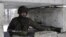 A Ukrainian serviceman guards a checkpoint near the town of Svitlodarsk.