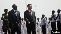 Chinese President Xi Jinping walks with Senegal's President Macky Sall after arriving at the Leopold Sedar Senghor International Airport, at the start of his visit to Dakar, Senegal July 21, 2018. REUTERS/Mikal McAllister