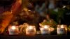 Candles are lit for those who died in the Boston Marathon bombings and the subsequent police manhunt at a memorial on Boylston Street in Boston on April 21.