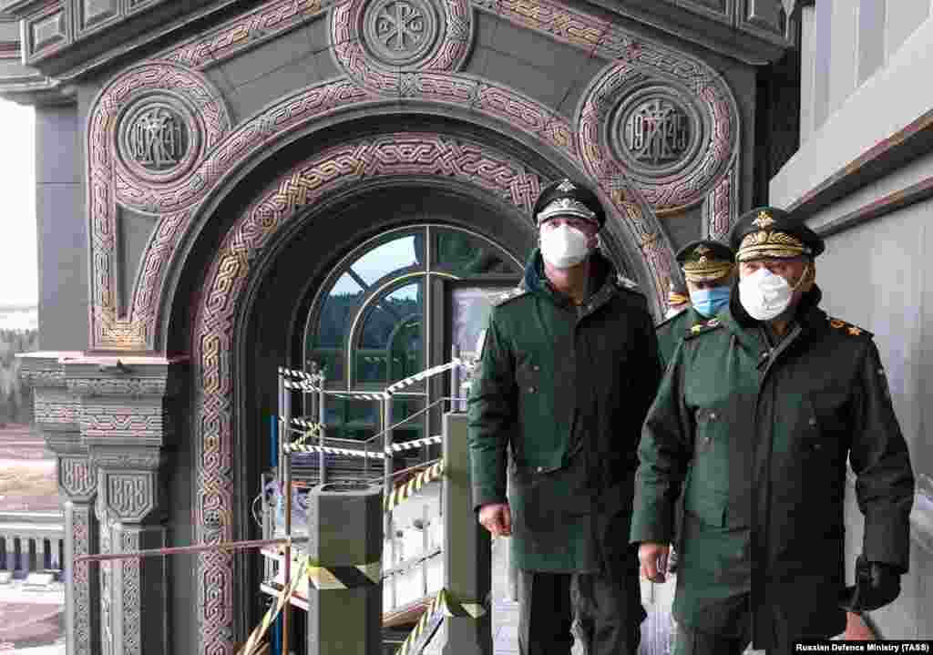 Russian Defense Minister Sergei Shoigu (right) visits the cathedral on April 22. The decorative reliefs in the background mark the start and finish of what Russians call the Great Patriotic War, which began for Soviets in 1941 with the Nazi invasion of the U.S.S.R. and ended with Germany&#39;s defeat in Europe in 1945.