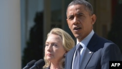 U.S. -- US Secretary of State Hillary Clinton watches as US President Barack Obama speaks in the Rose Garden of the White House in Washington, DC, 12Sep2012