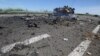 Ukraine -- A destroyed armored vehicle is seen on the road of the airport in the south of Luhansk, July 14, 2014