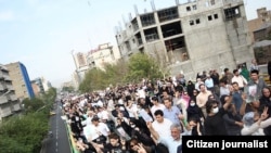 Election protesters, many dressed in black, march on June 18, declared by the opposition as a day of mourning for those killed in the rallies.