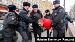 Russian police officers detain a protester during a rally to demand freedom for political prisoners in Moscow earlier this year. 