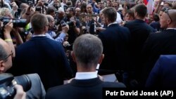 Czech Prime Minister Andrej Babis (center) is heckled while delivering a speech to honor the victims of the Soviet-led invasion of Czechoslovakia in 1968 at a ceremony in Prague on August 21.