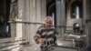 A man lights a candle inside the war-damaged Armenian Ghazanchetsots (Holy Savior) Cathedral in Shushi on October 8, 2020, a month before Nagorno-Karabakh’s historic city was captured by advancing Azerbaijani forces. 