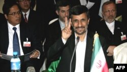 Iranian President Mahmud Ahmadinejad flashes a victory sign during the D-8 summit in Abuja on July 8.