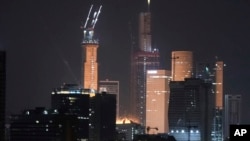 A projectile hits a building (center) in Tel Aviv on June 14.