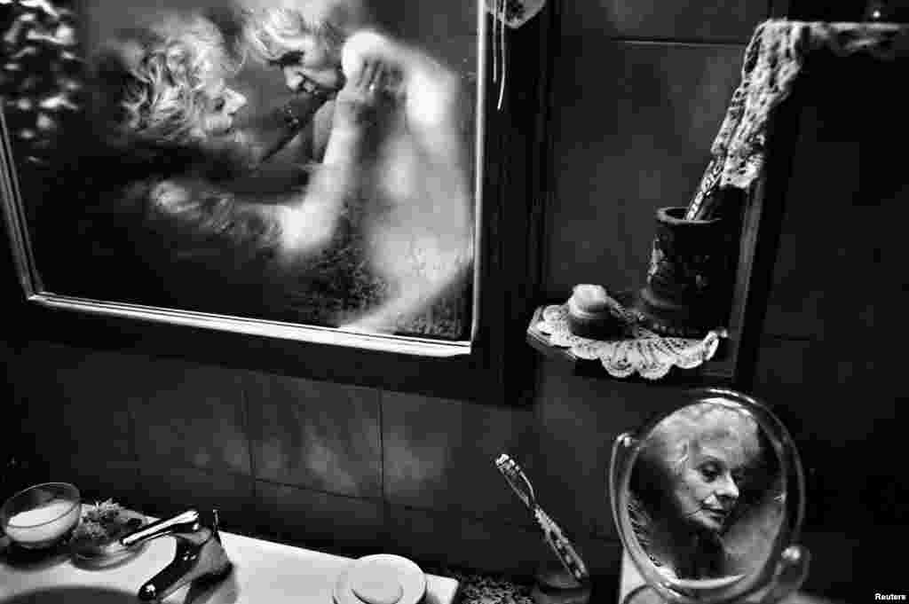 Fausto Podavini of Italy won first prize in the Daily Life Stories category with the series "Mirella." This picture shows Mirella taking care of her husband, Luigi, who suffers from Alzheimer's disease, in Rome.