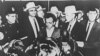 Lee Harvey Oswald appears at a press conference after his arrest in Dallas on November 22, 1963.