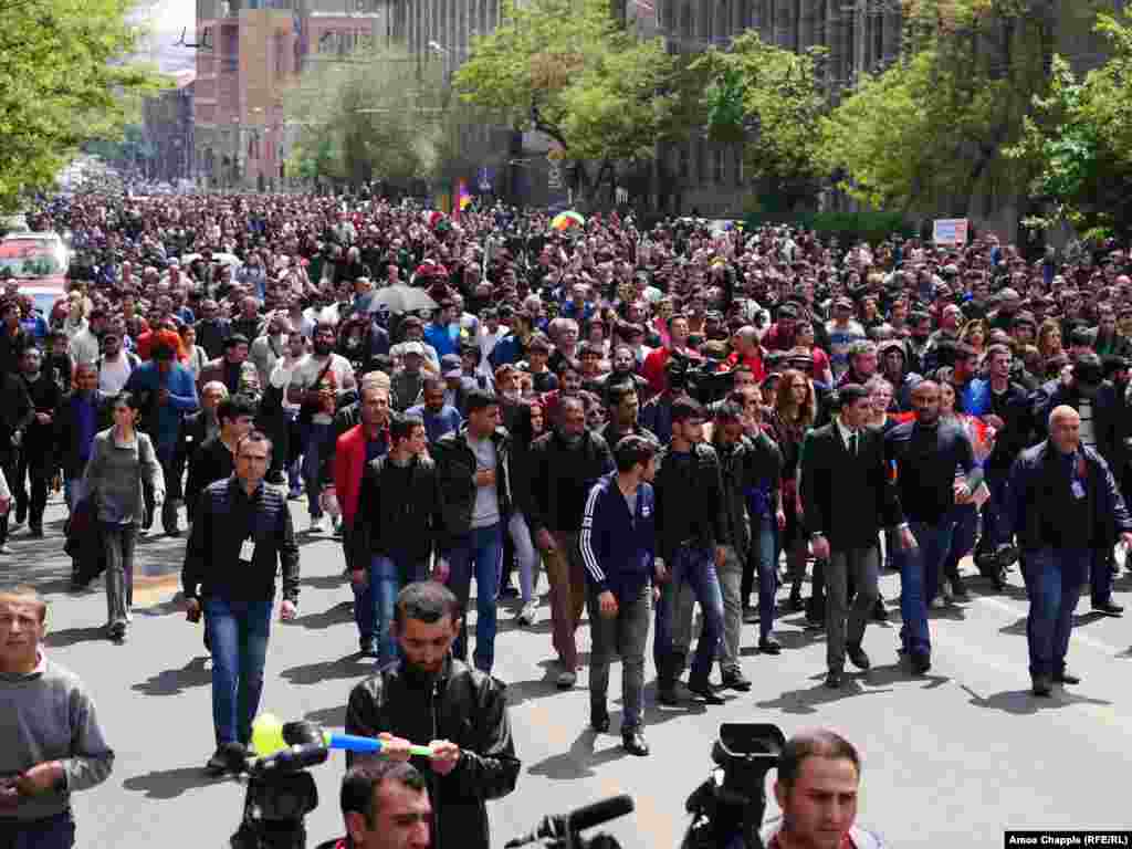 Now without a leader, protesters march back to the center of Yerevan.