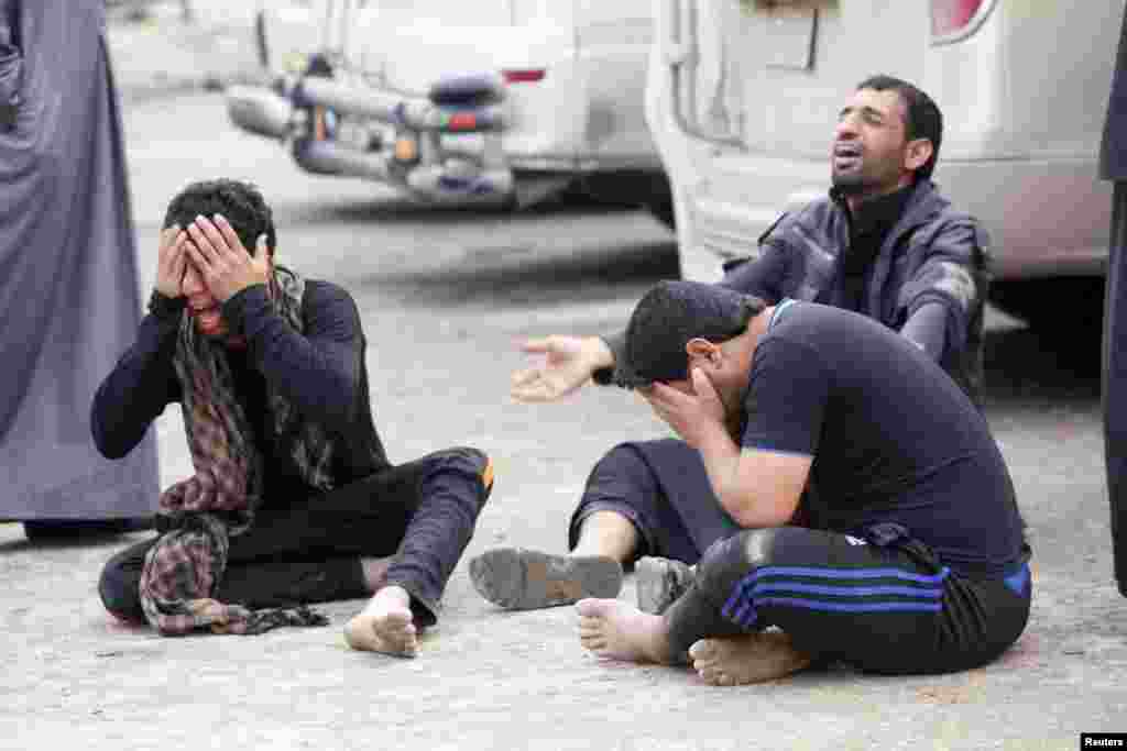 Mourners grieve during the funeral of their relative, who was killed in an attack by suicide bombers in Najaf, 160 kilometers south of Baghdad, Iraq. (Reuters/Alaa al-Marjani)